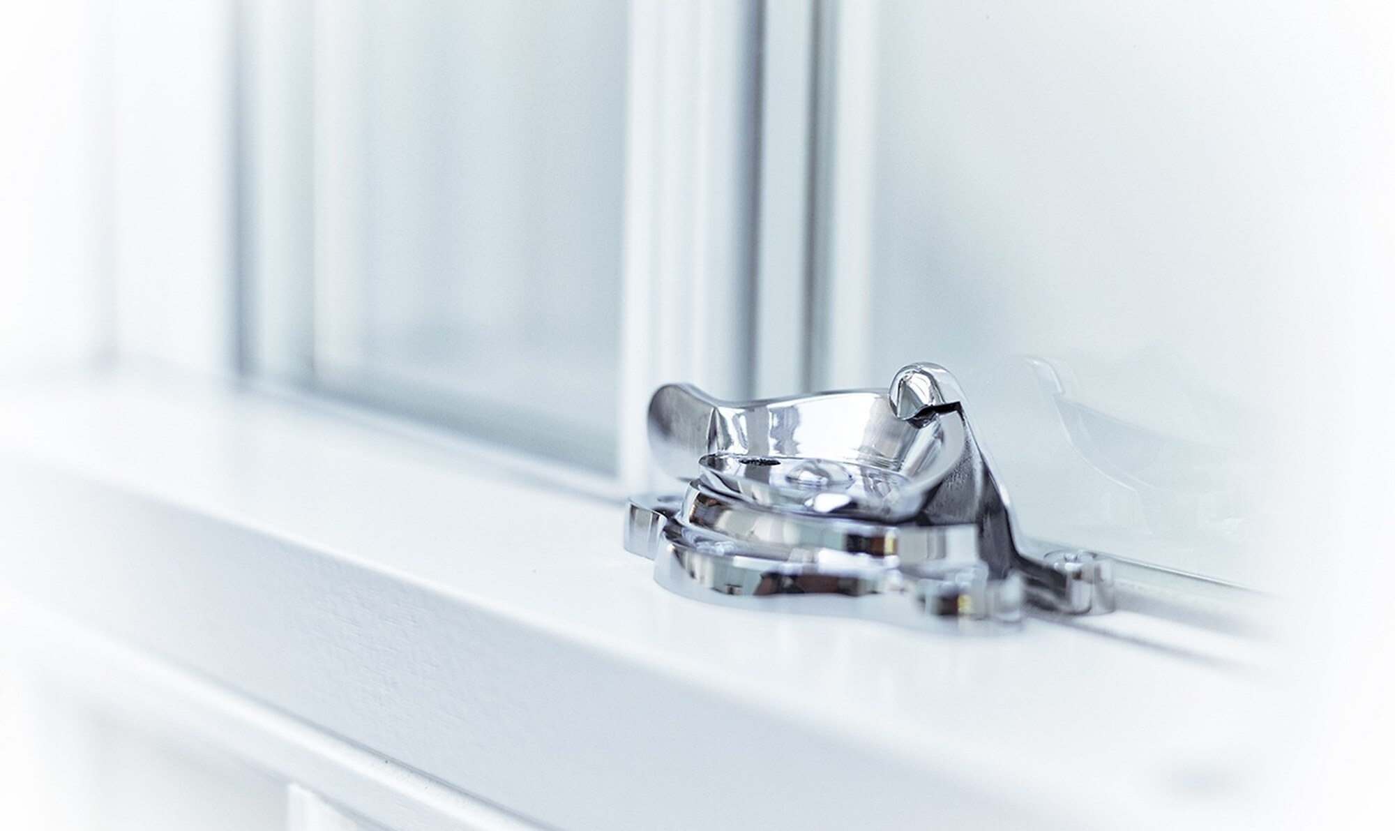 Chrome fitch fastener on a white sash window