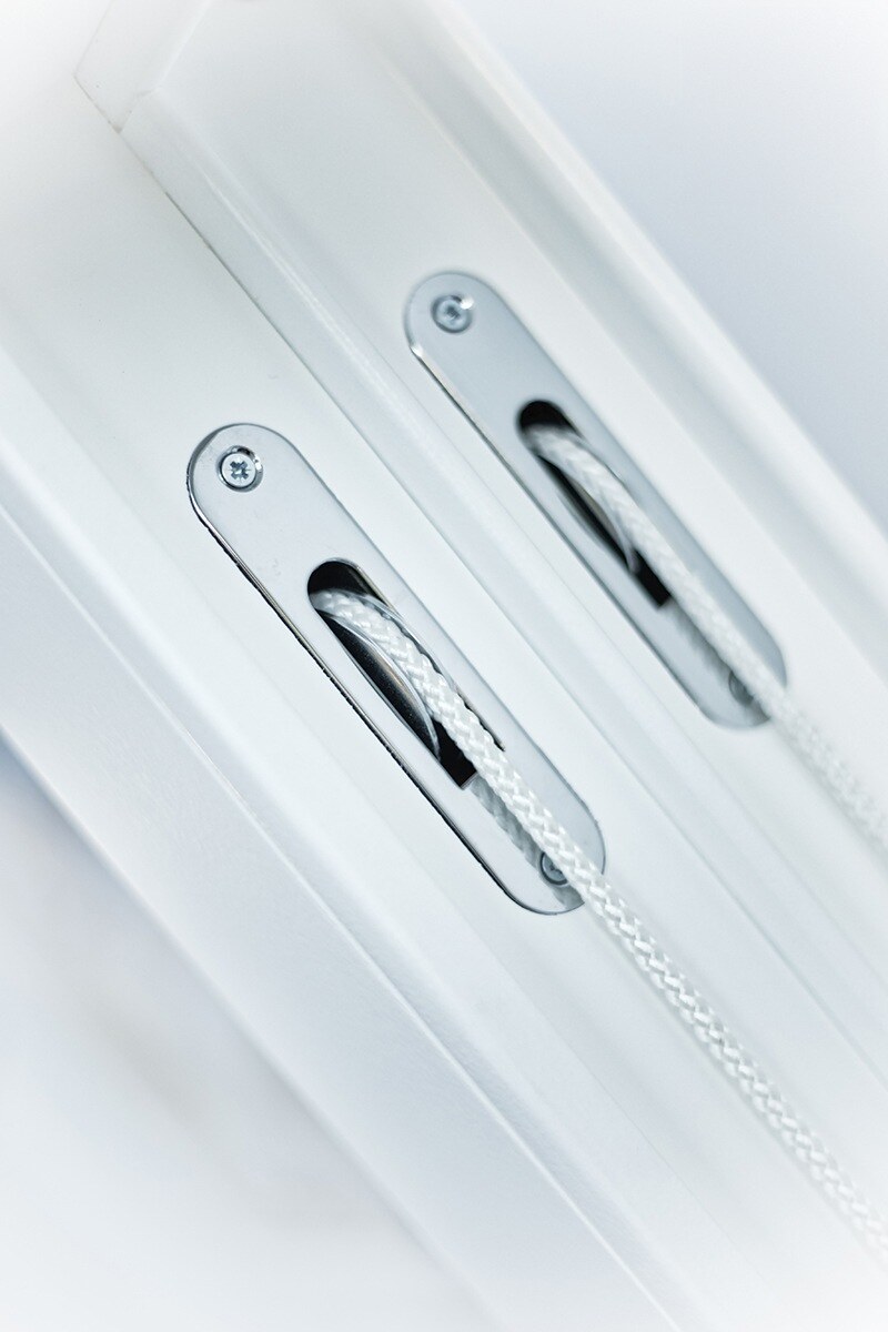 Sash cords running over brass-faced pulleys