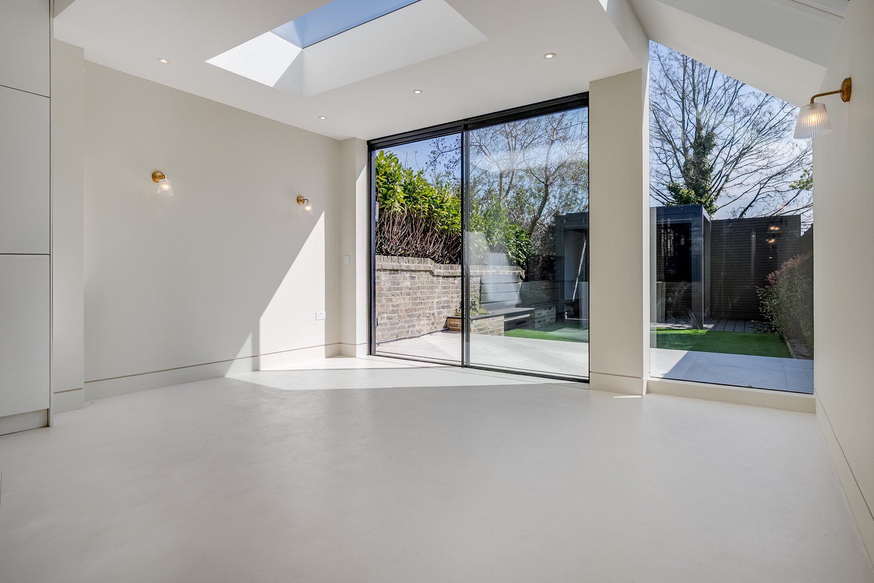 Extension with a flat rooflight and floor to ceiling sliding doors