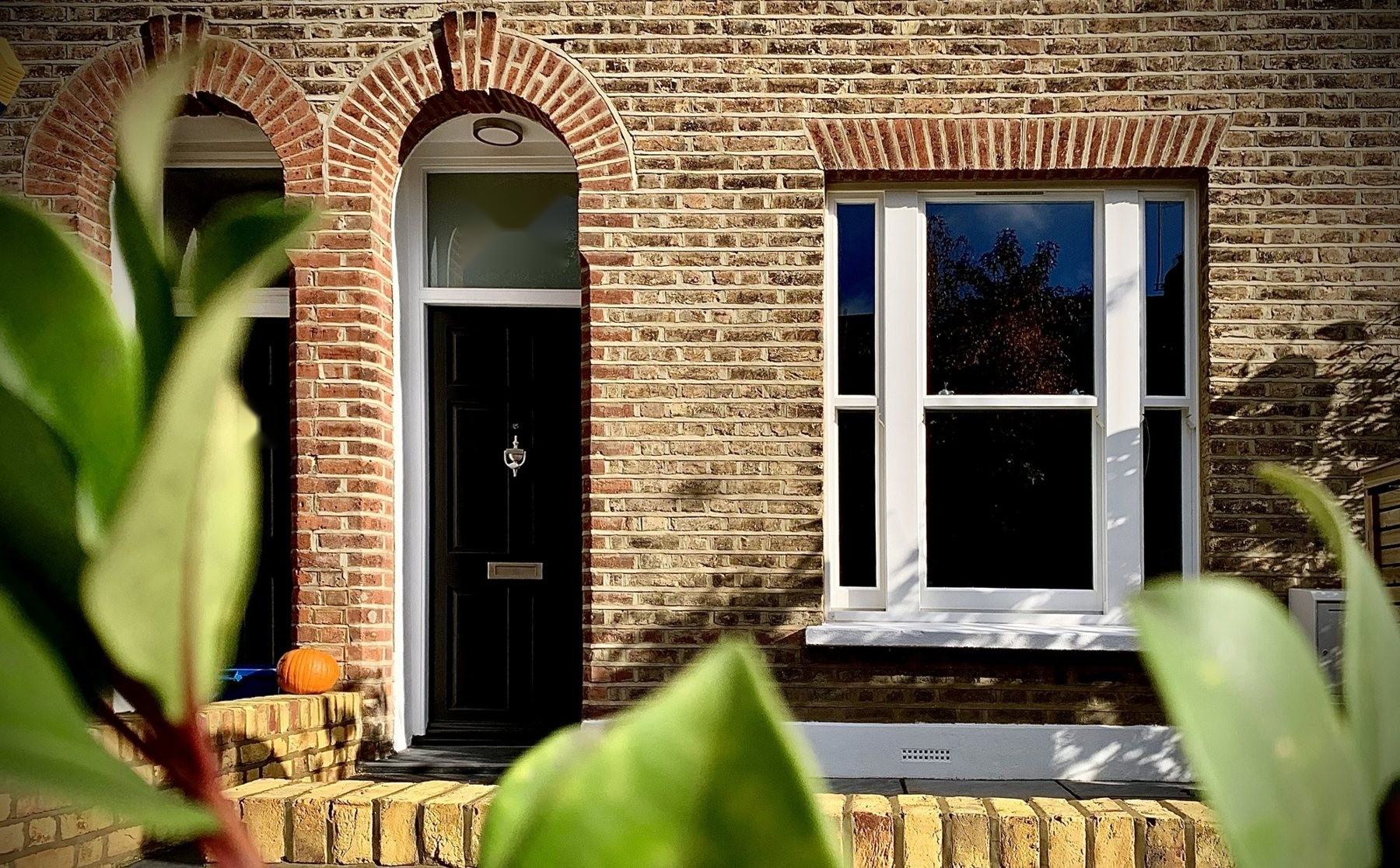 Victorian terraced house with a new white timber box sash window